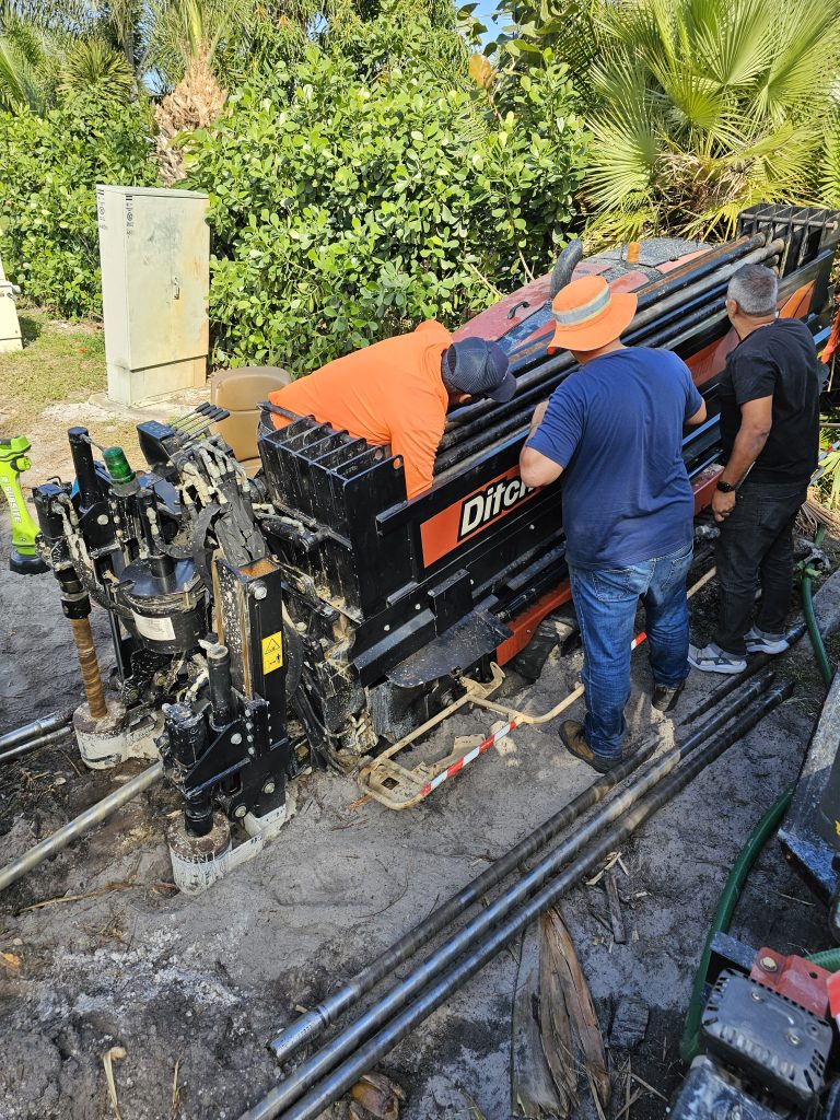 Crew operating horizontal directional drilling equipment for underground utility installation in Palm Beach County, Florida