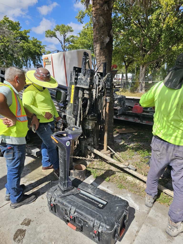 Crew operating horizontal directional drilling equipment for underground utility installation