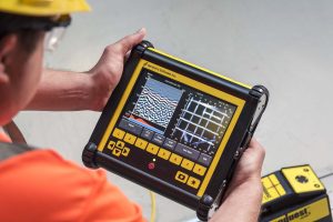 Technician using GPR scanning equipment to detect underground utilities