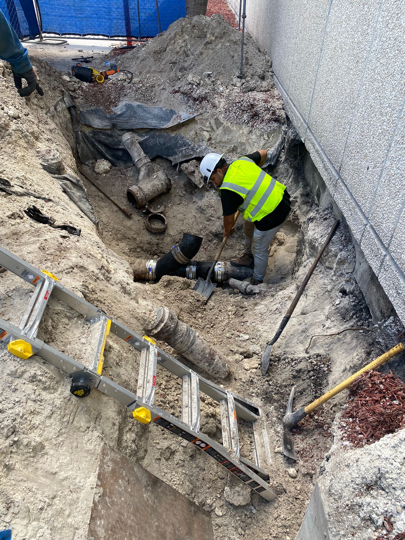Utility worker performing underground utility excavation in Pembroke Pines, Florida
