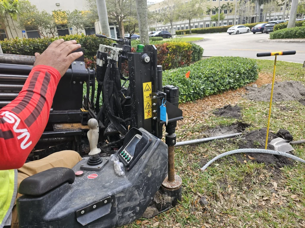 Operator using Horizontal Directional Drilling equipment to install underground utility conduits with minimal surface disruption.