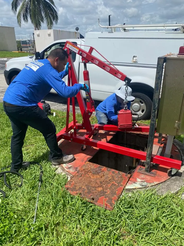 Crew operating underground utility drilling equipment at a construction site